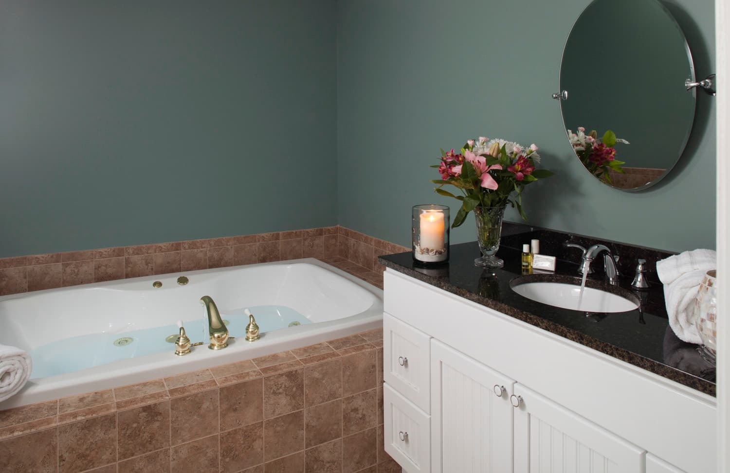 The large two person spa tub and granite topped vanity in the bathroom.