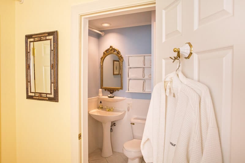 The sink in the bathroom and the robe provided for guest use