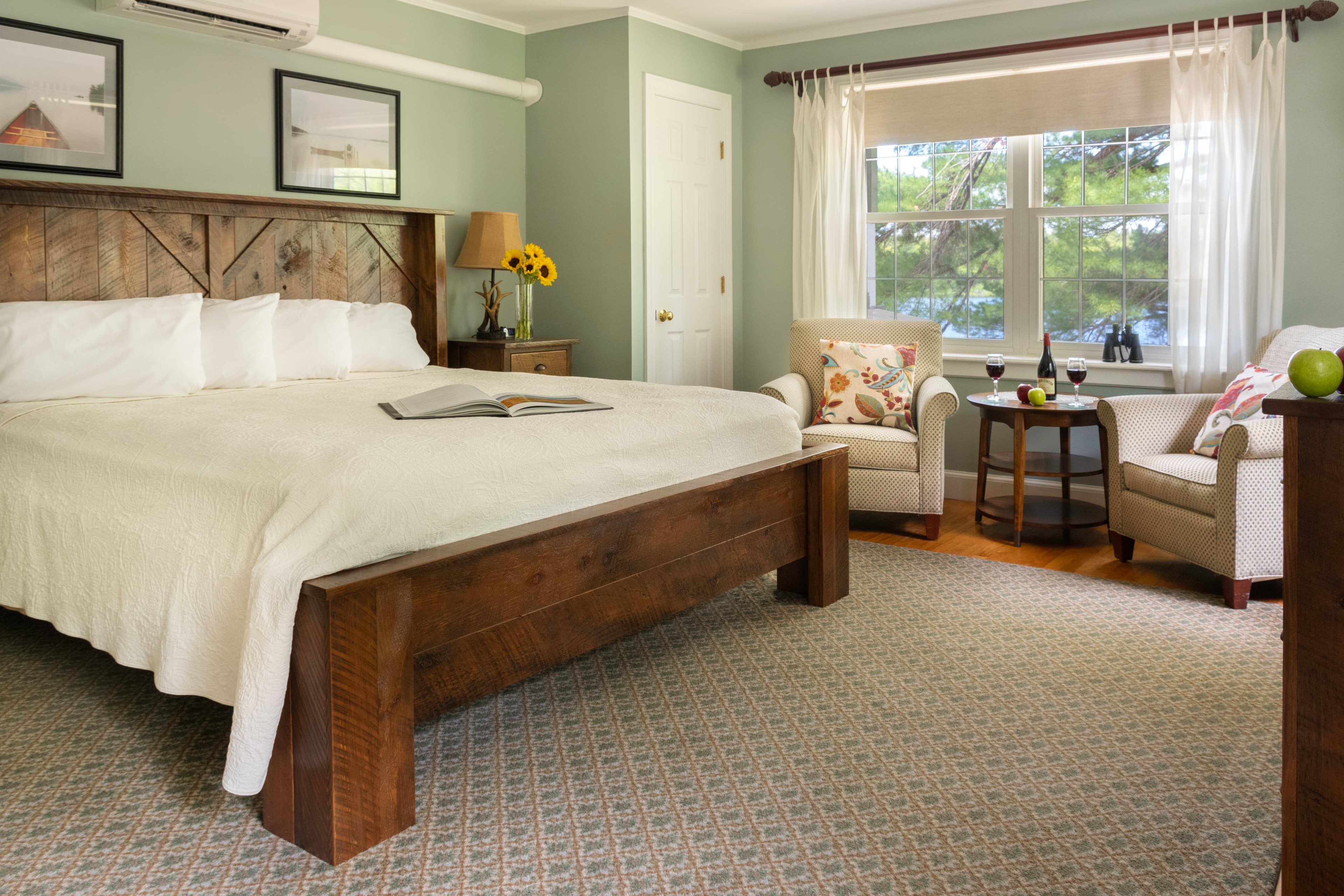 The two twin beds setup as a king bed with two comfortable chairs by the window.