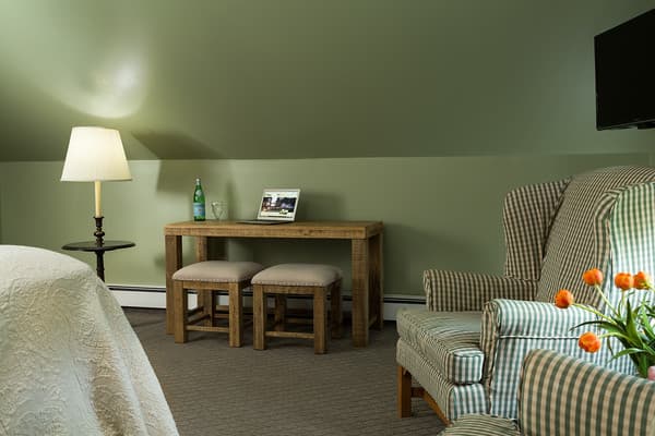 Bedroom showing the workstation (desk with two small benches).