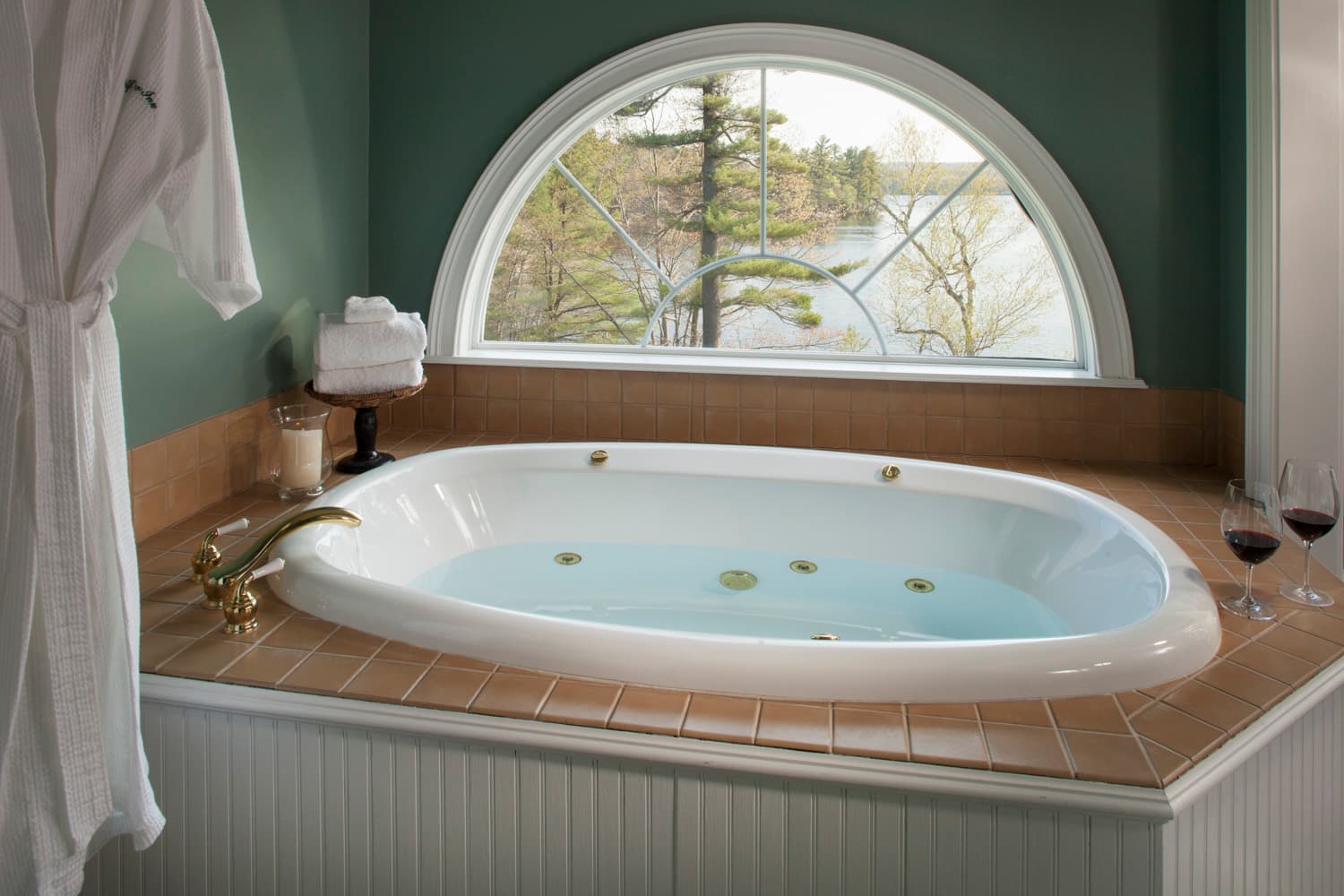 The large two person spa tab with half-moon window overlooking Tripp Lake.