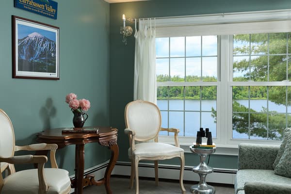View of the other seating area with armed chairs and loveseat overlooking the lake.