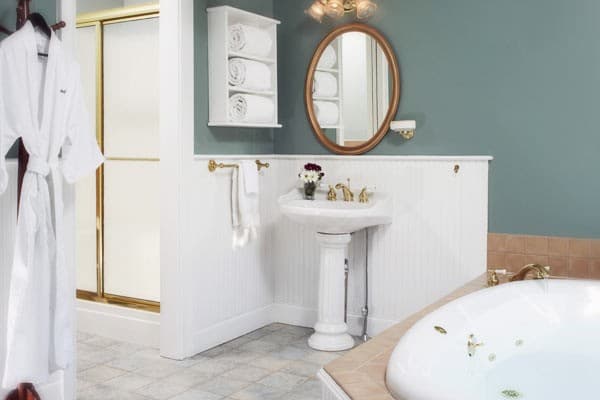The bathroom spa tub, sink, mirror and stall shower.