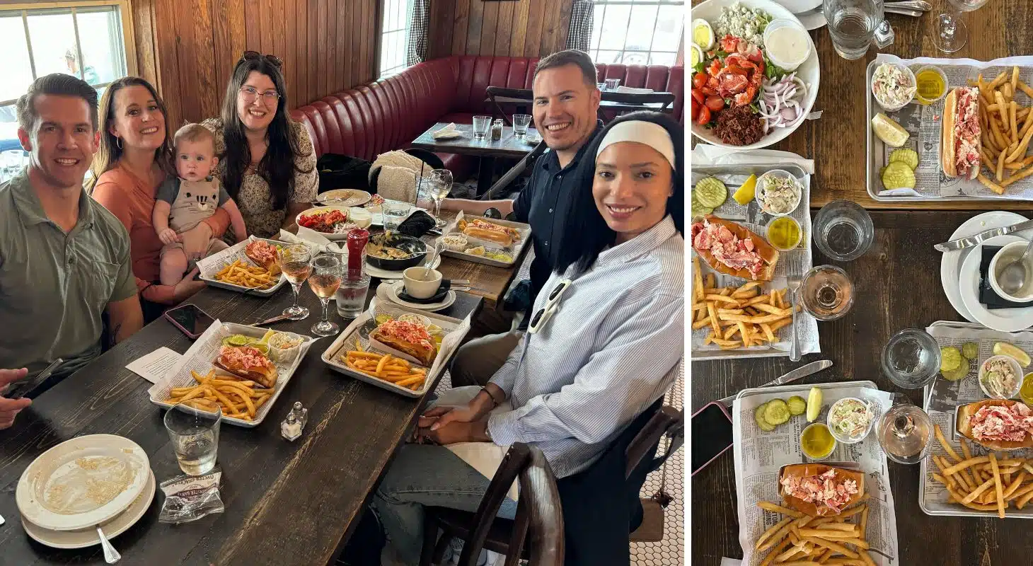 A group of five people enjoys a meal with lobster rolls and fries at a cozy restaurant.