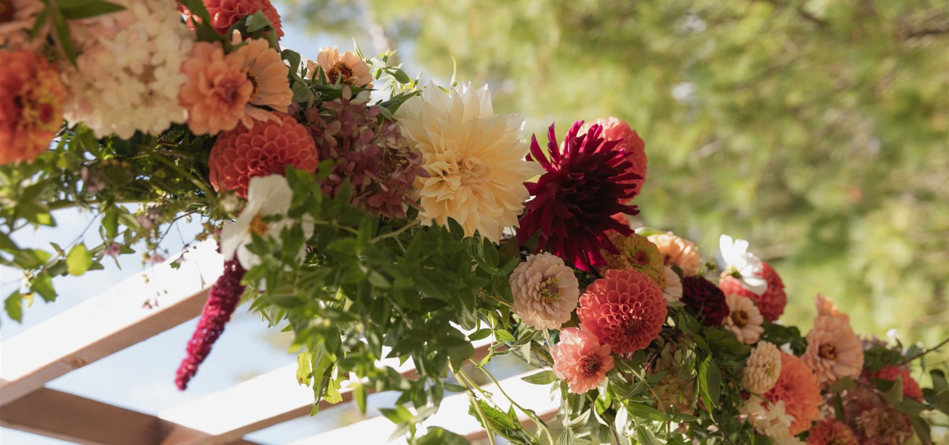 A colorful floral arrangement featuring various blooms and greenery.