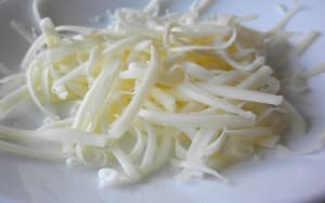 Shredded white cheese on a plate.