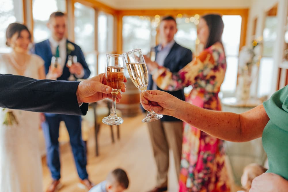 A group of people at a celebration toasting with glasses of champagne.