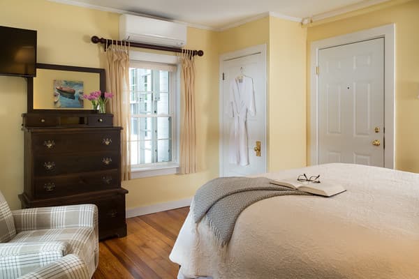 Alternate bedroom view showing the queen bed, dresser and flat screen TV.