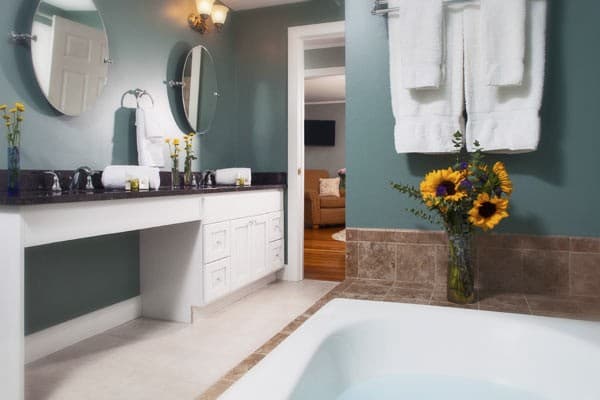 Bathroom view of the granite topped, 2 sink vanity and mirrors.