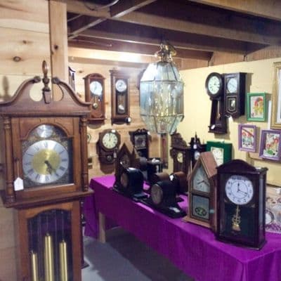 antique clock display at the willow flea market in maine