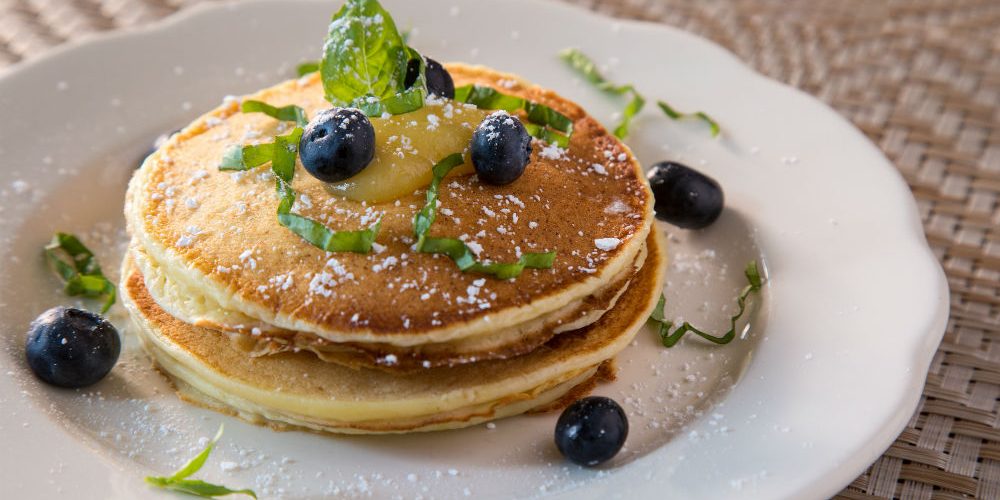 Pancake stack seasoned with powdered sugar and blueberries