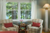 Sitting area with plush chairs next to window in the Wolf Cove Inn's Moosehead Lake room