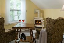 Sitting area with wine and gas fireplace in the Mount Katahdin room