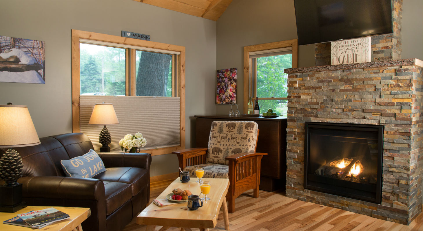 Sitting area with coffee by brick fireplace and television
