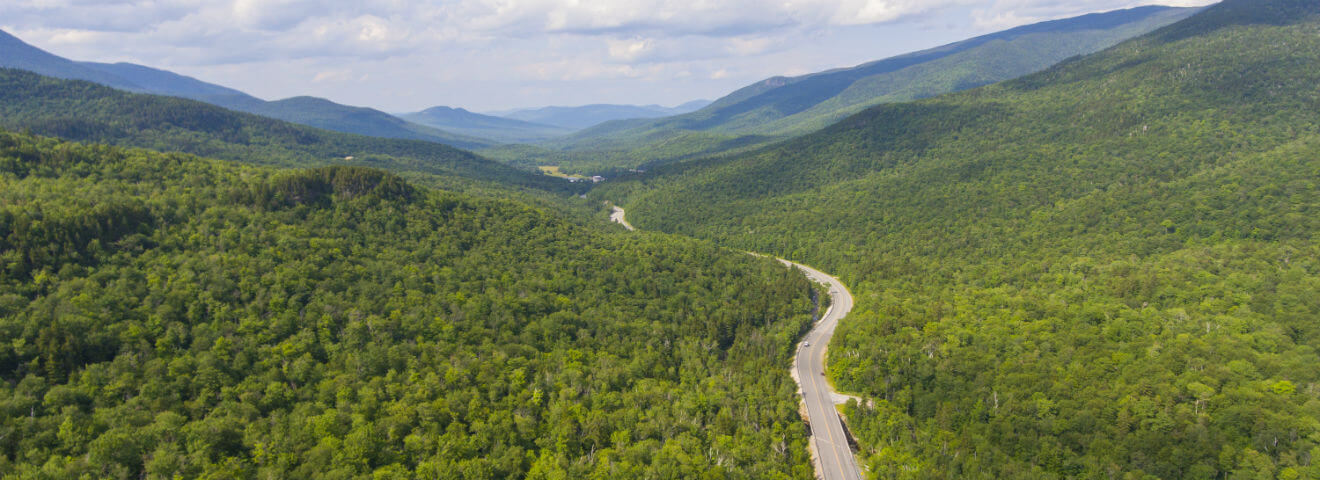 A road winding through the northern mountains in Maine