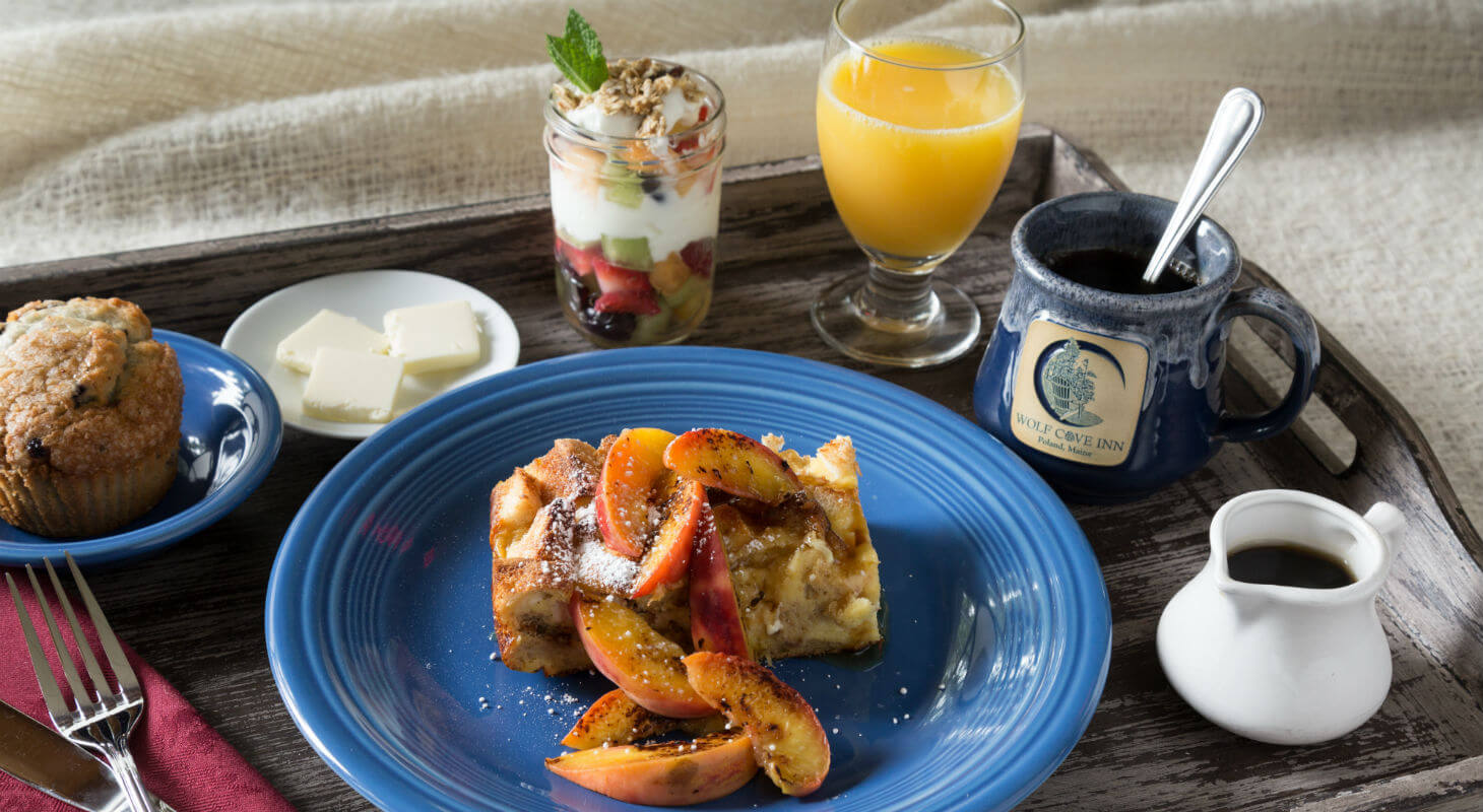 Fresh breakfast tray with fruit, yogurt, and orange juice