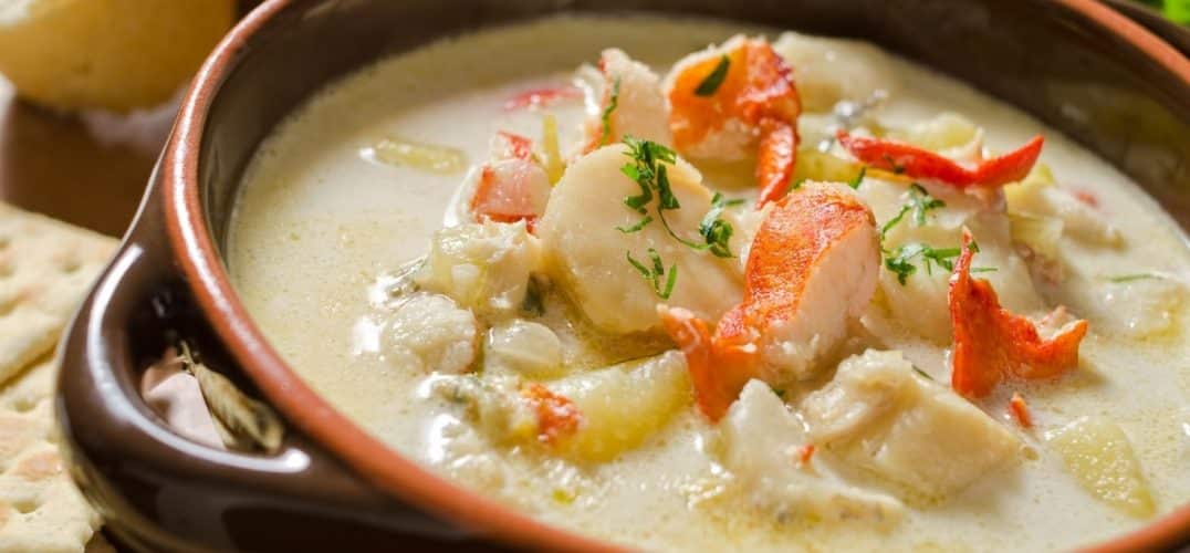 Bowl of hot seafood chowder with homemade bread and crackers