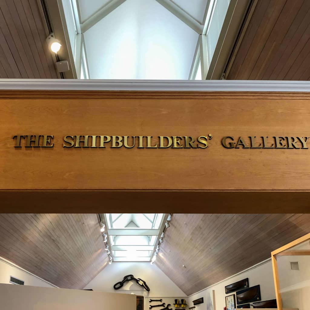 Wooden overhead sign at the museum that reads: The Shipbuilding Gallery