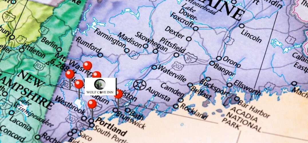 A map of Maine with part of New Hampshire with pin in approximate location of towns near Poland, Maine, where Wolfe Cove Inn is located.