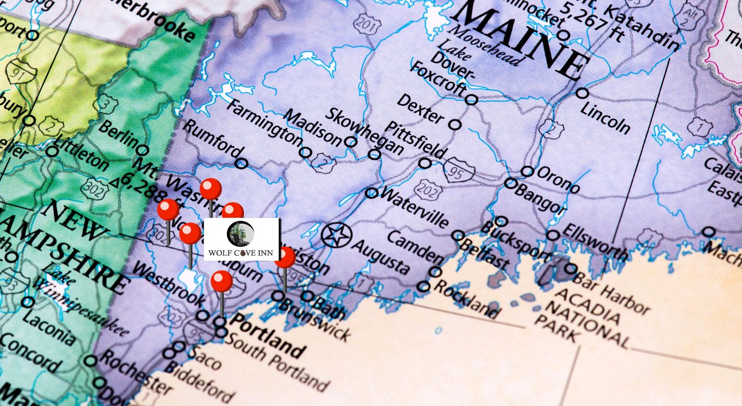 A map of Maine with part of New Hampshire with pin in approximate location of towns near Poland, Maine, where Wolfe Cove Inn is located.