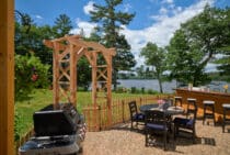 Private garden with gas grill, dining table, and bar top