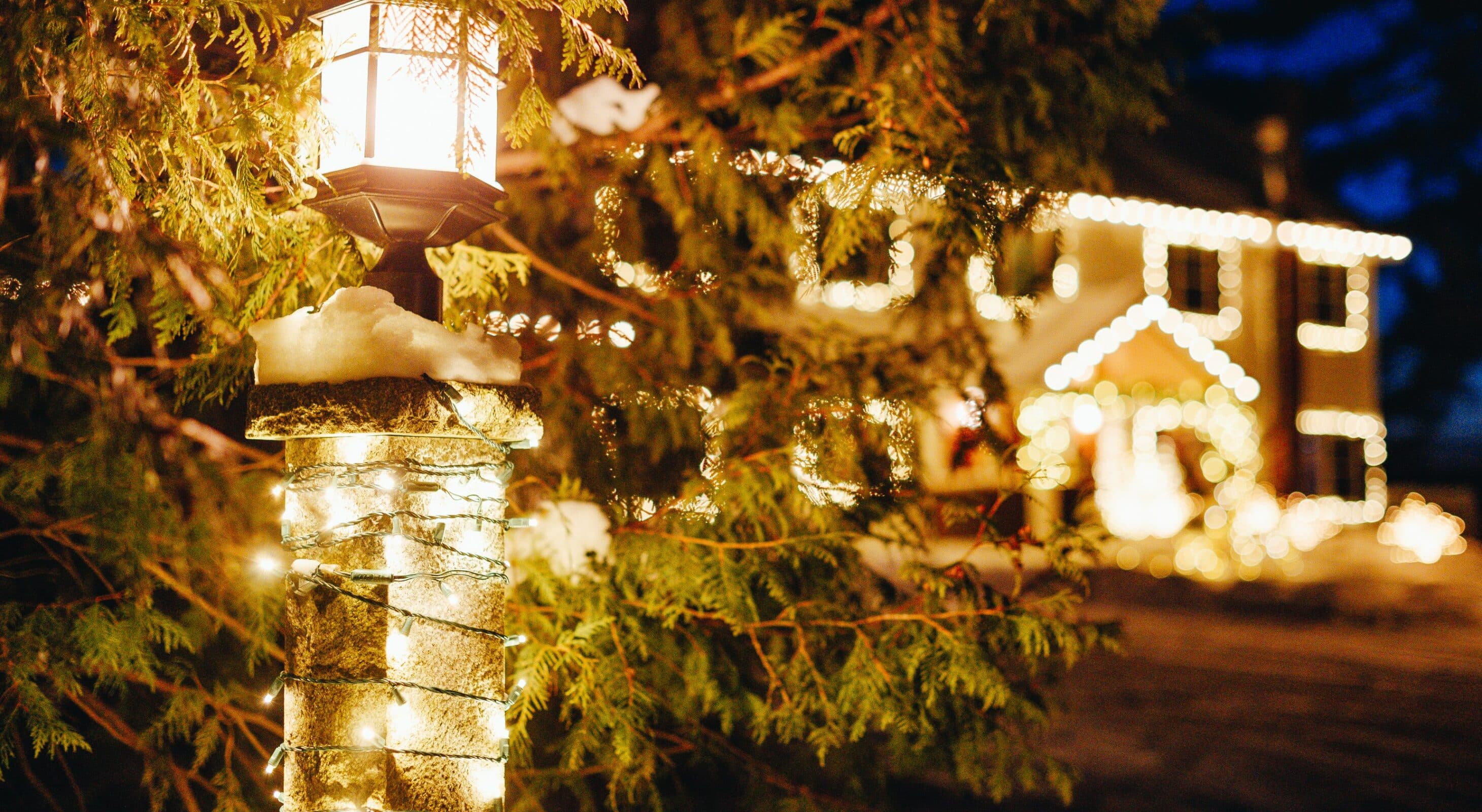 A festive light post and holiday filled entryway to Wolf Cove Inn