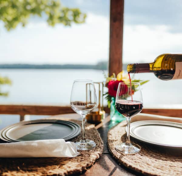 A server pouring a glass of wine for the romance dinner.