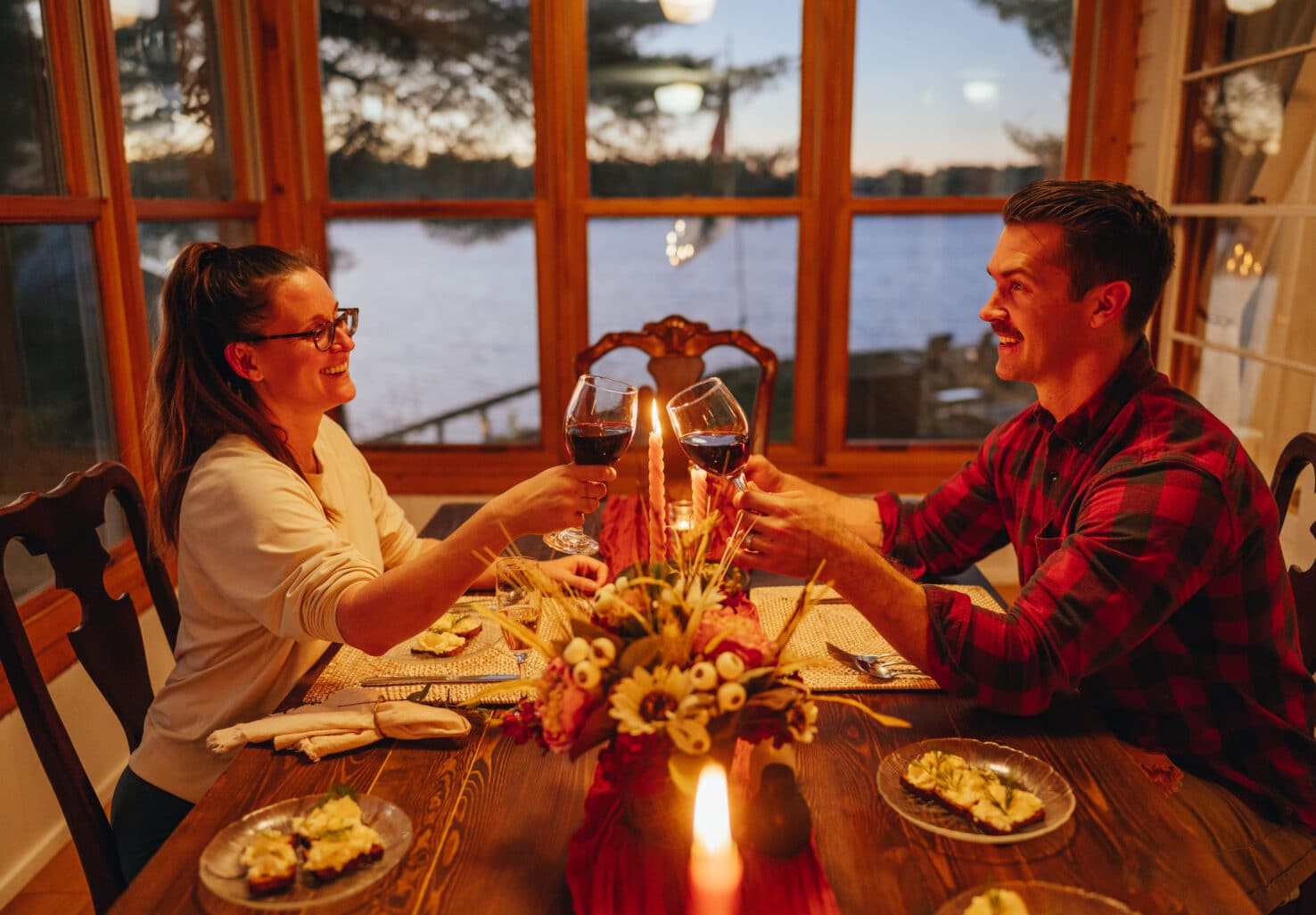 A couple enjoying a lakeside sunporch romance dinner