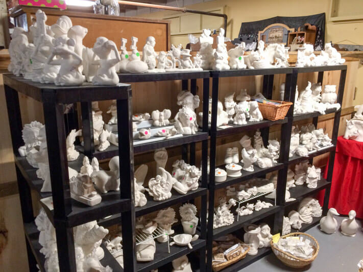 White Figurines displayed in wooden brown racks At The Willows